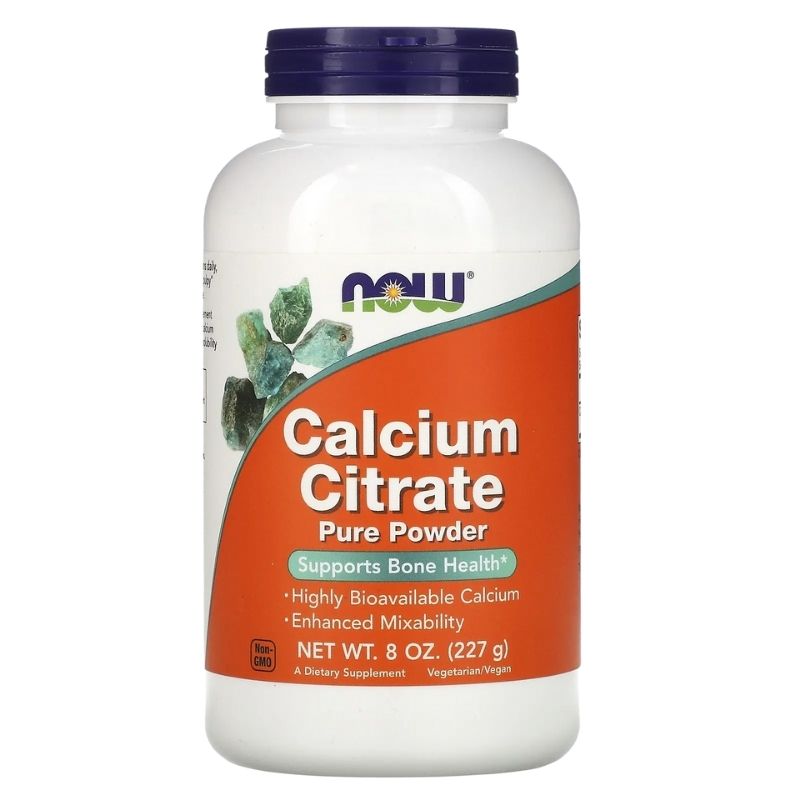 A white bottle of NOW Calcium Citrate Pure Powder with a dark blue cap. The label is orange and white, featuring the NOW logo and an image of calcium crystals. The label reads 'Calcium Citrate Pure Powder - Supports Bone Health* - Highly Bioavailable Calcium - Enhanced Mixability.' The net weight is 8 oz (227 g), and it is marked as non-GMO and suitable for vegetarians/vegans. The product is described as a dietary supplement.