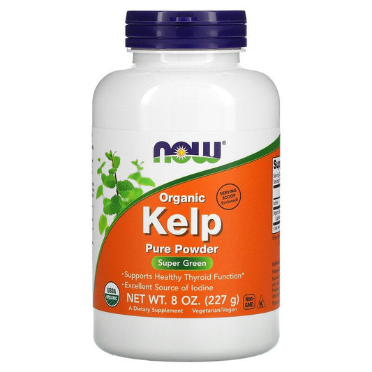 White bottle of NOW Organic Kelp Pure Powder. The label is orange and green with the NOW logo at the top. It indicates the product supports healthy thyroid function and is an excellent source of iodine. The bottle contains 8 oz (227 g) of powder and is labeled as USDA organic, non-GMO, and vegetarian/vegan. A serving scoop is enclosed