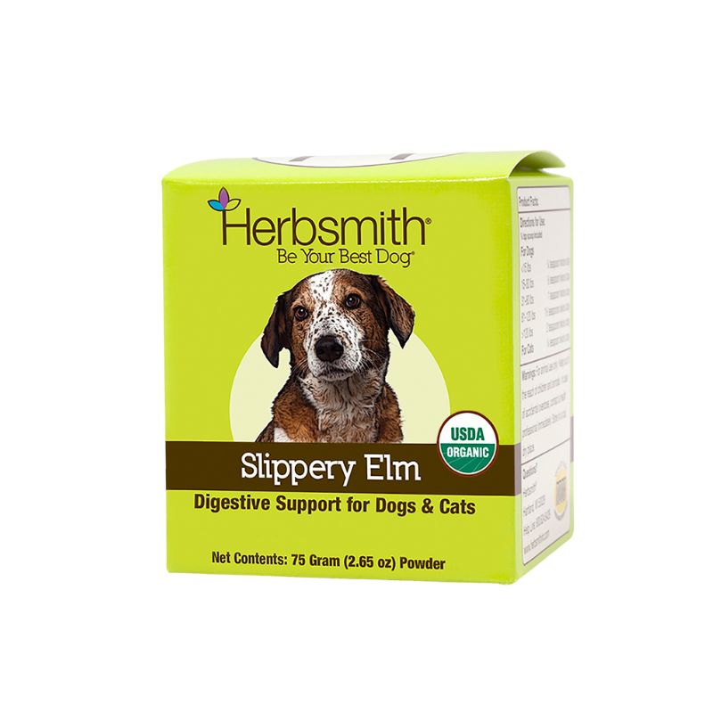 A green box of Herbsmith "Slippery Elm," labeled "Digestive Support for Dogs & Cats," features a photo of a brown and white speckled dog. The Herbsmith logo and tagline "Be Your Best Dog" are at the top. The product name "Slippery Elm" appears in white text on a brown strip, with "Digestive Support for Dogs & Cats" in yellow below. The box contains 75 grams (2.65 ounces) of powder and includes a USDA Organic seal on the bottom right.